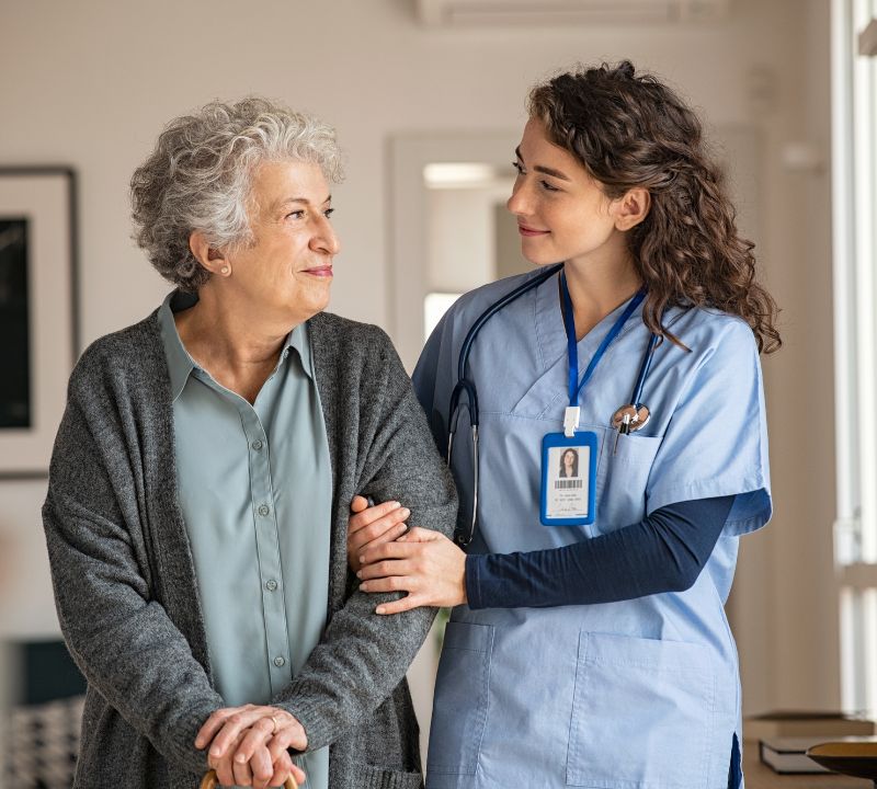 Elderly woman with a caretaker