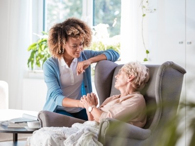 Elderly woman with a caretaker